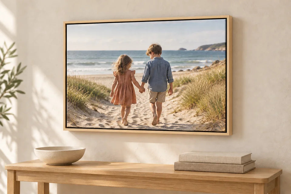 The same children’s beach canvas shown with a pale bare wood floating frame.