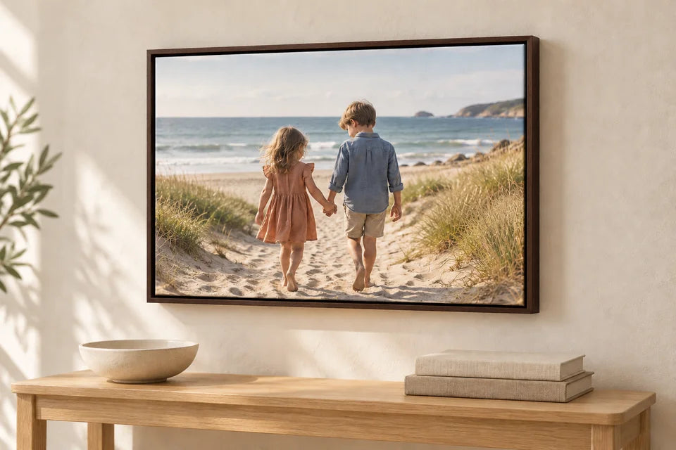 The same children’s beach canvas shown with a dark brown wood floating frame.