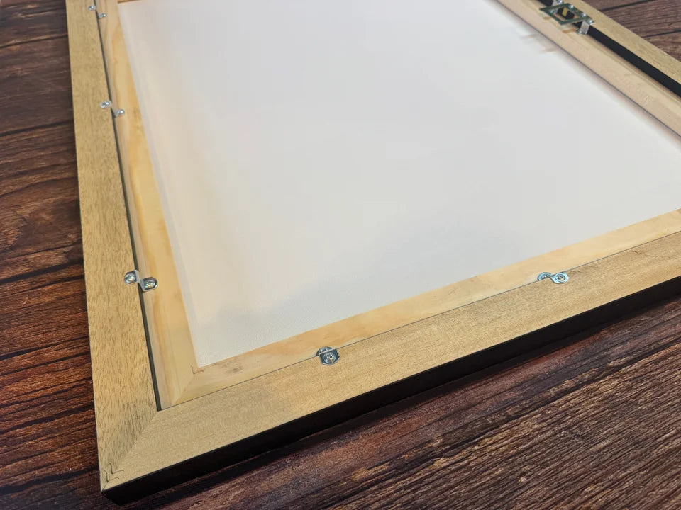 The rear of an actual YI2C floating-frame canvas, showing the inner pine support, outer wood surround and metal fixings.