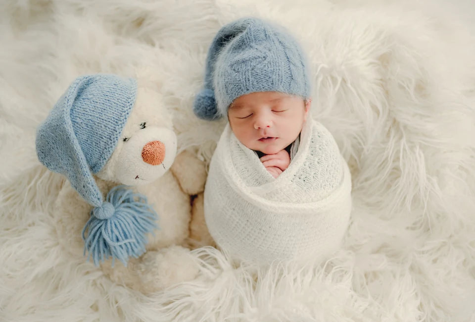 Sleeping baby beside a teddy bear, used to illustrate a changing photo crop