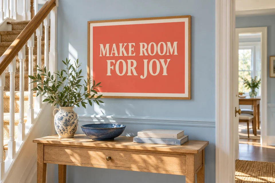 A coral Word Art poster with cream lettering displayed on a light blue hallway wall.