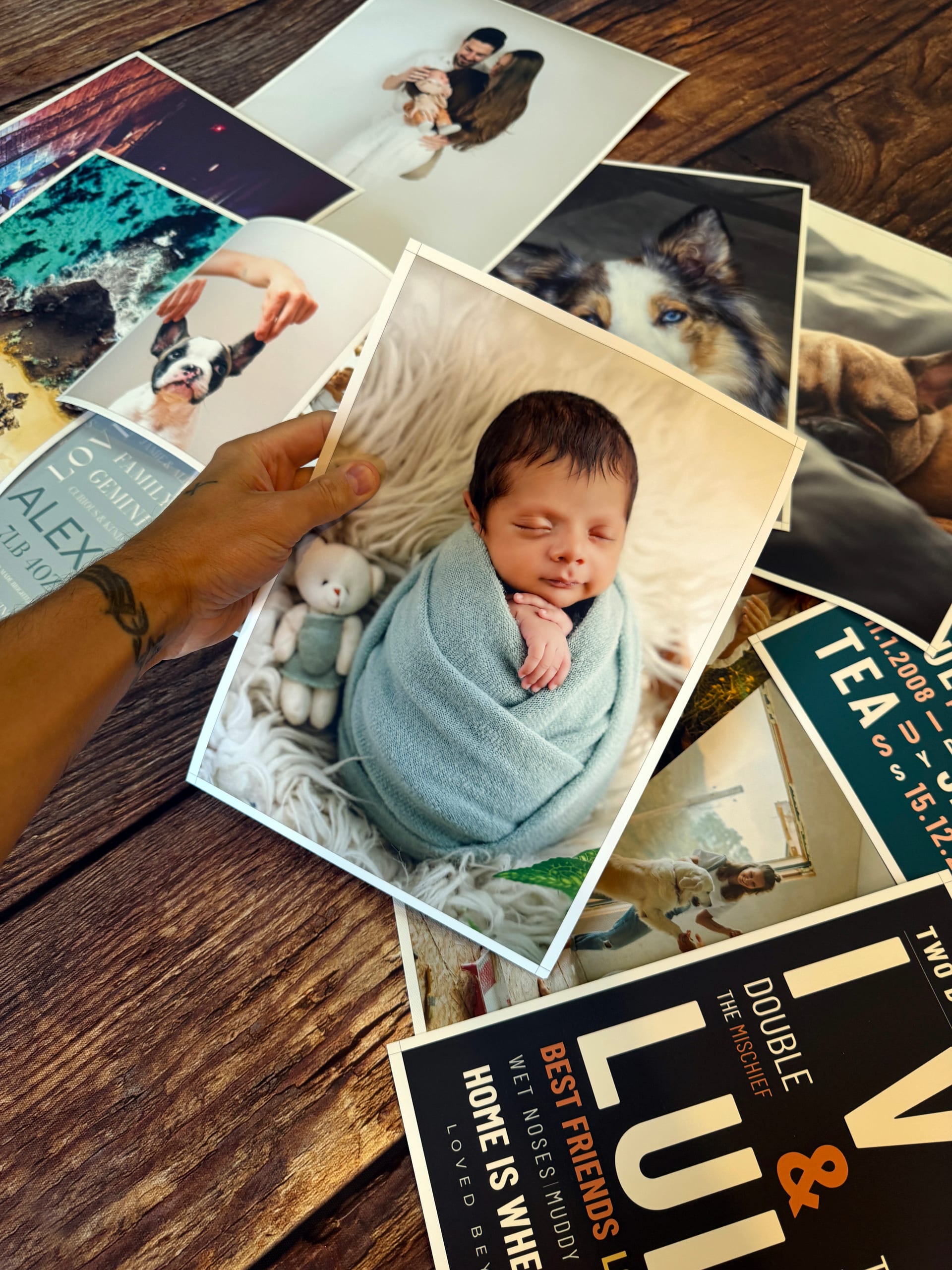 A baby photo poster held above a selection of photographic and Word Art prints