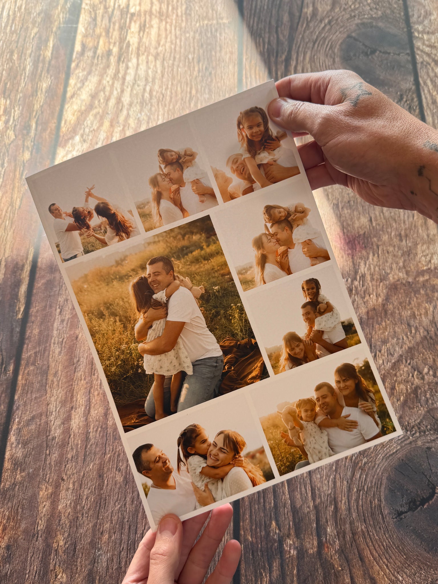 A personalised photo collage print held above a dark wooden table.