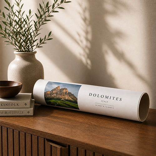 Rolled photographic poster print displayed on a wooden cabinet