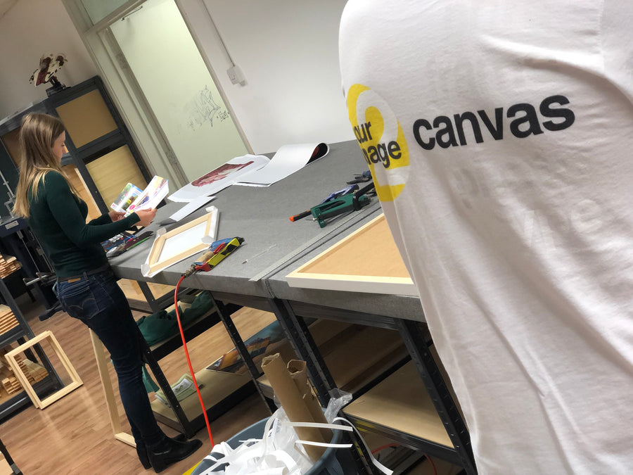 YI2C workshop team preparing canvas frames and printed artwork