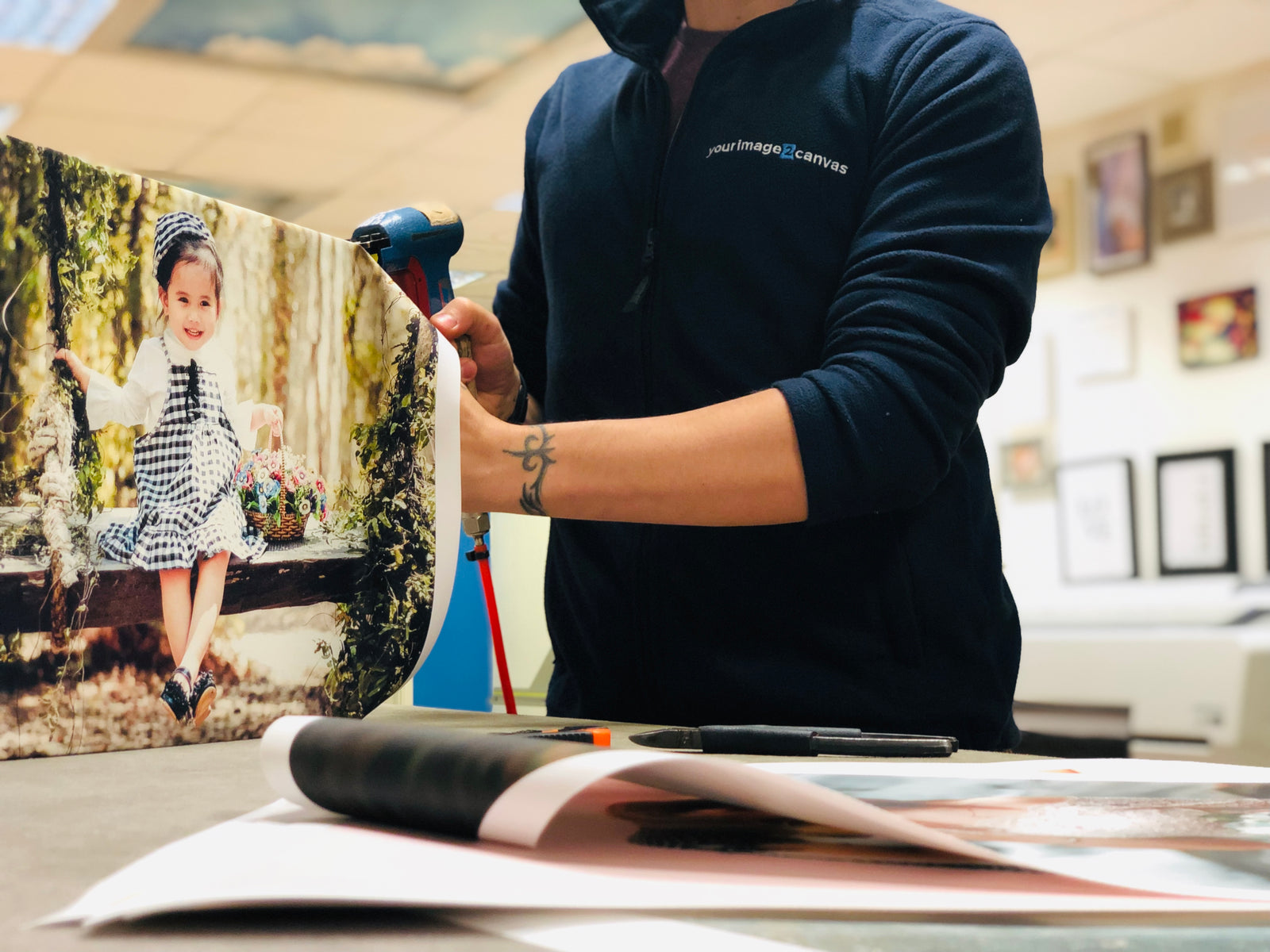 YI2C team member hand-finishing a personalised photo canvas