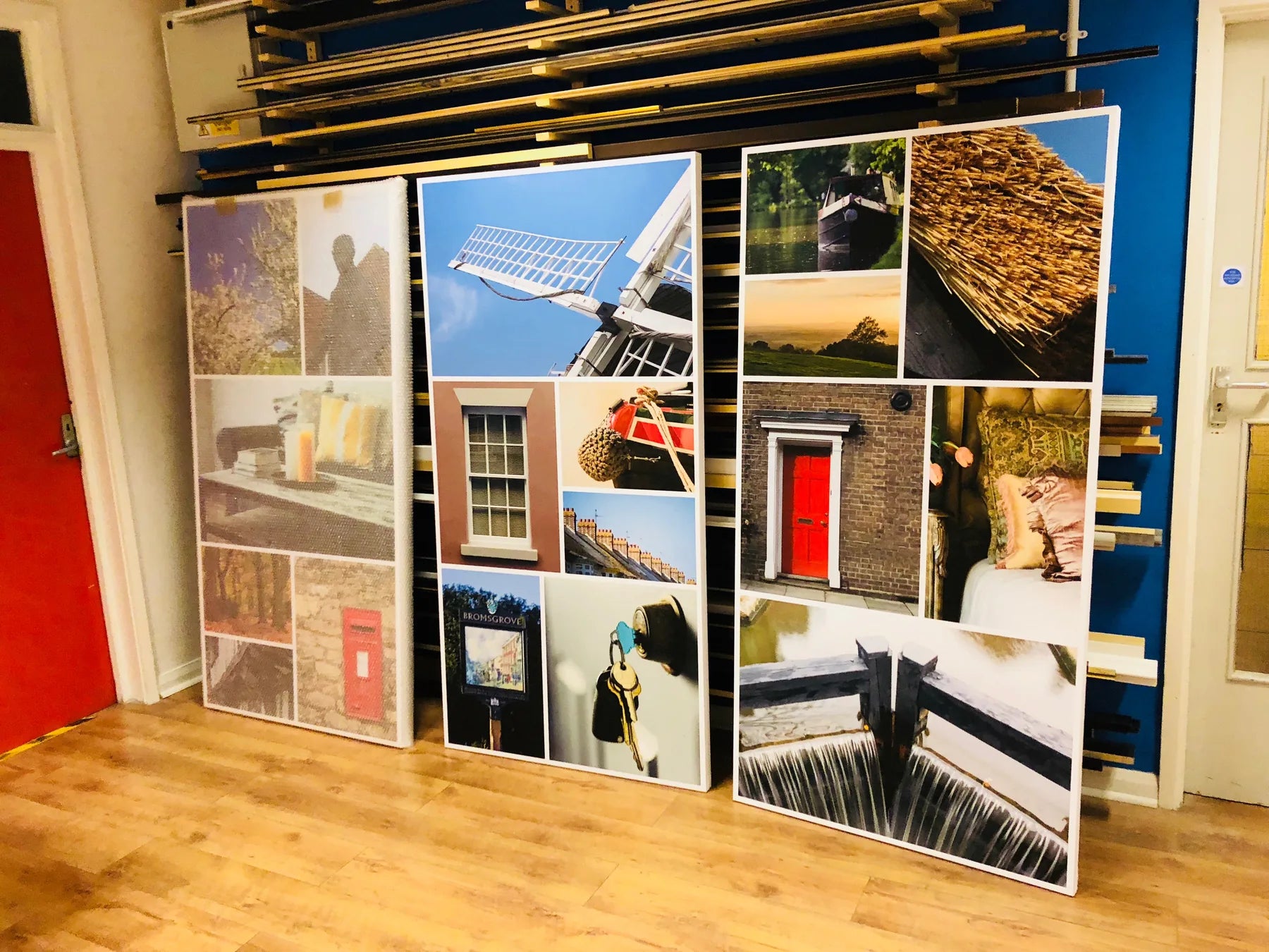 Large finished photographic display panels standing inside the workshop