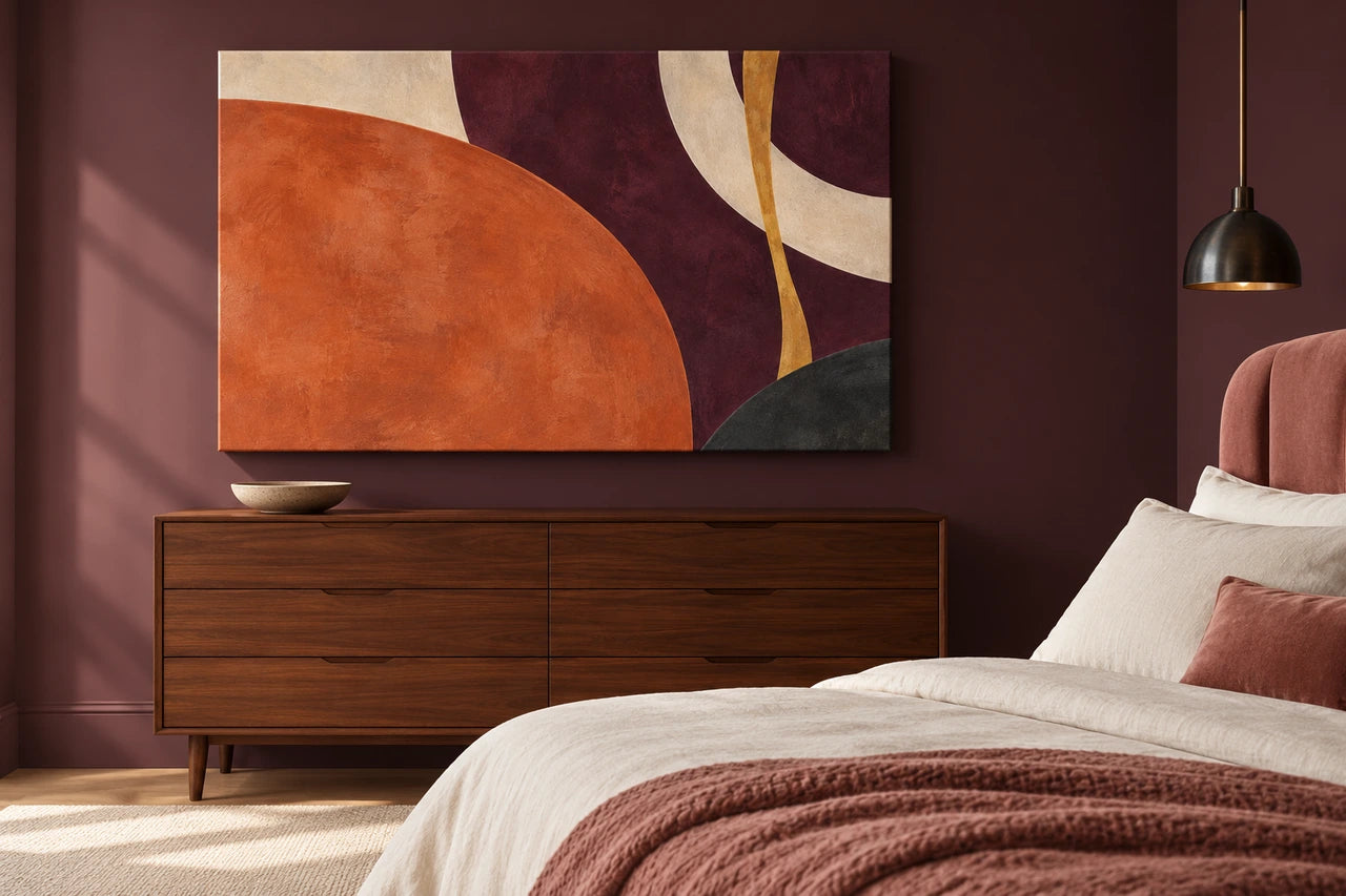 An imagined plum bedroom with a large terracotta abstract canvas over a walnut chest.