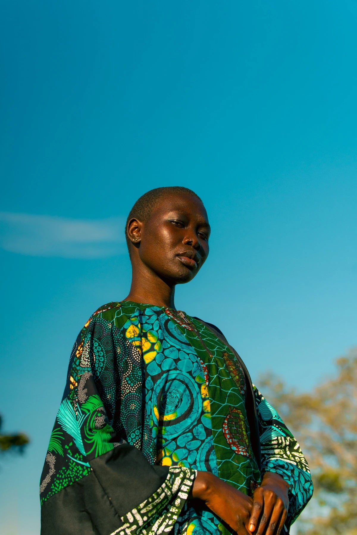 Closer turquoise outfit portrait against blue sky