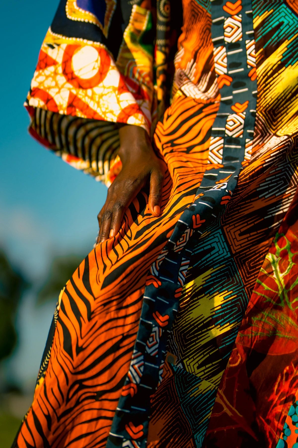 Close view of a hand and patterned orange fabric