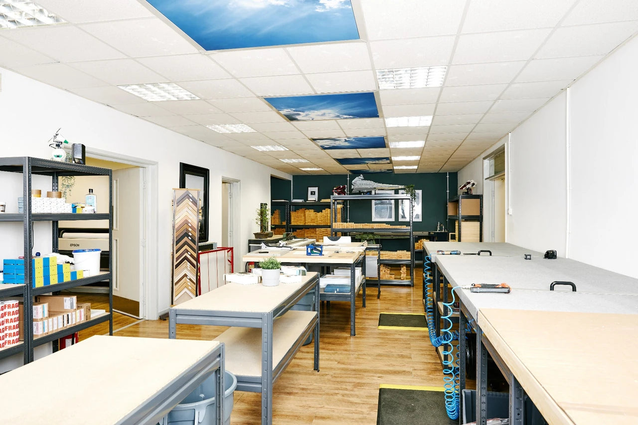 The YI2C canvas workshop at 8am, with clear workbenches and frame timber ready for the day.