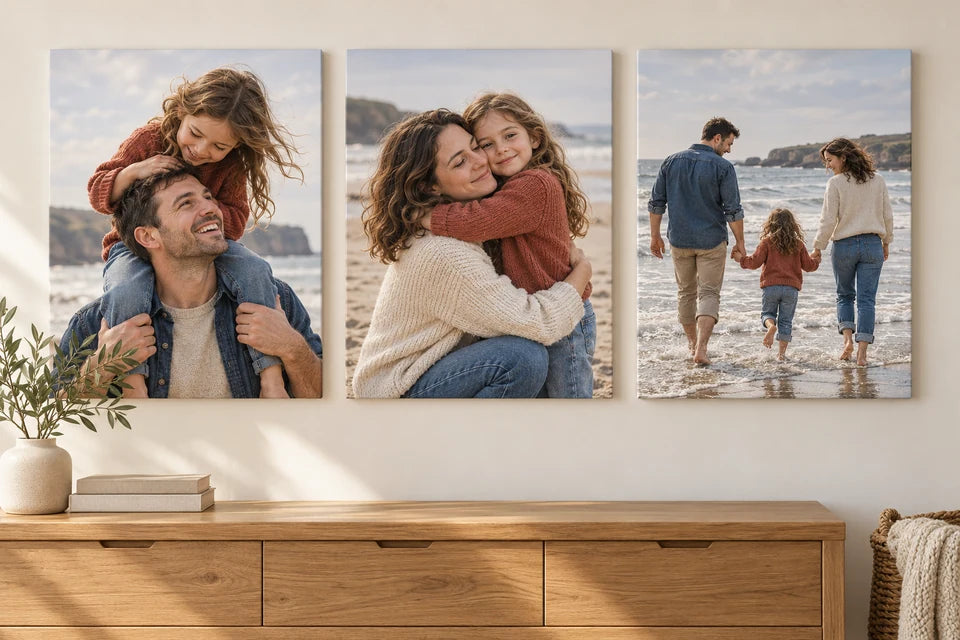Three coordinated family beach photographs displayed as canvas prints above an oak sideboard