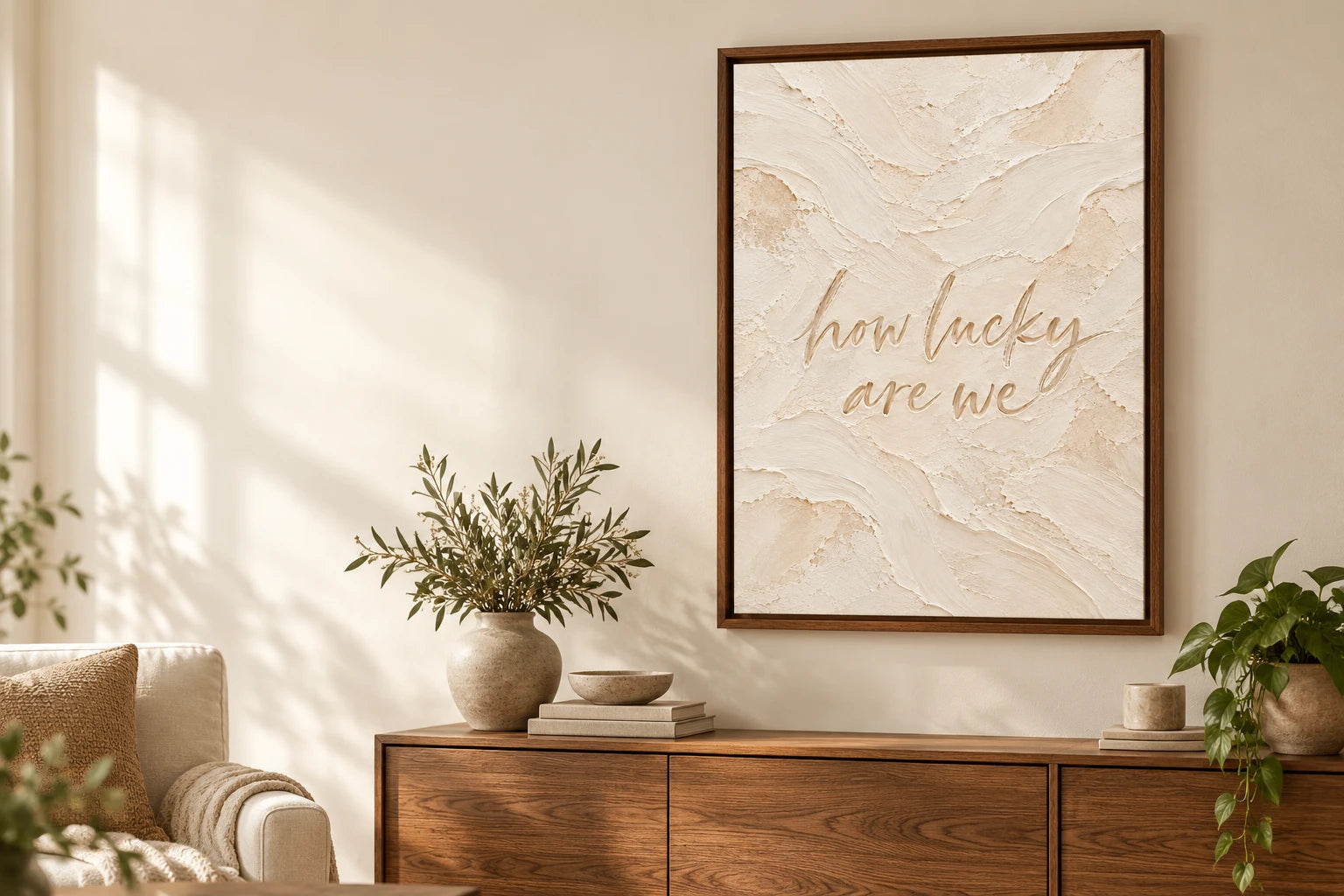How lucky are we quote canvas in a brown wood floating frame above a console.