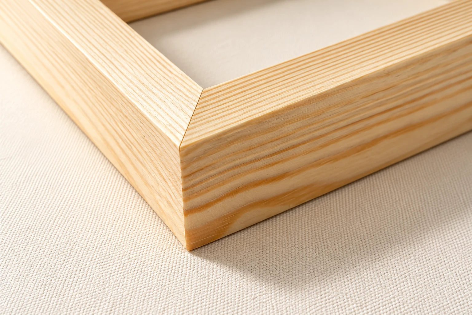 Illustration of a joined solid pine canvas stretcher corner showing wood grain and fine canvas fabric.