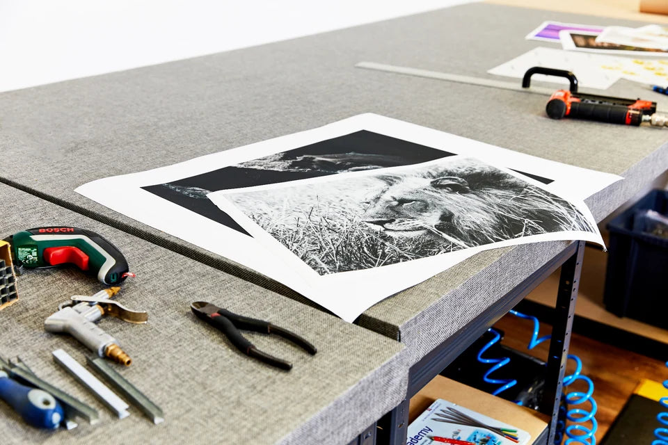 Printed canvas and stretching tools laid out on our workbench