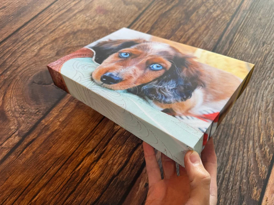 A dog photo canvas held at an angle to show the wrapped side