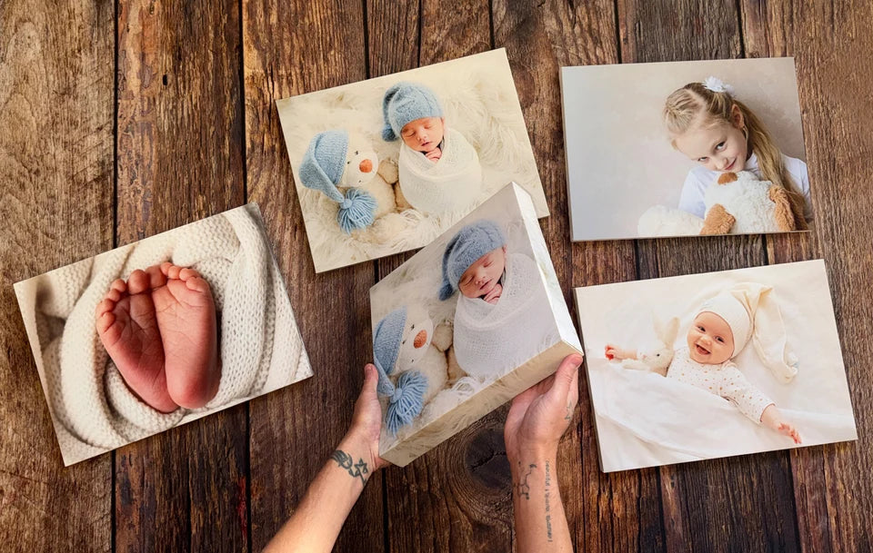 A collection of baby and family photo canvases on our wooden worktop