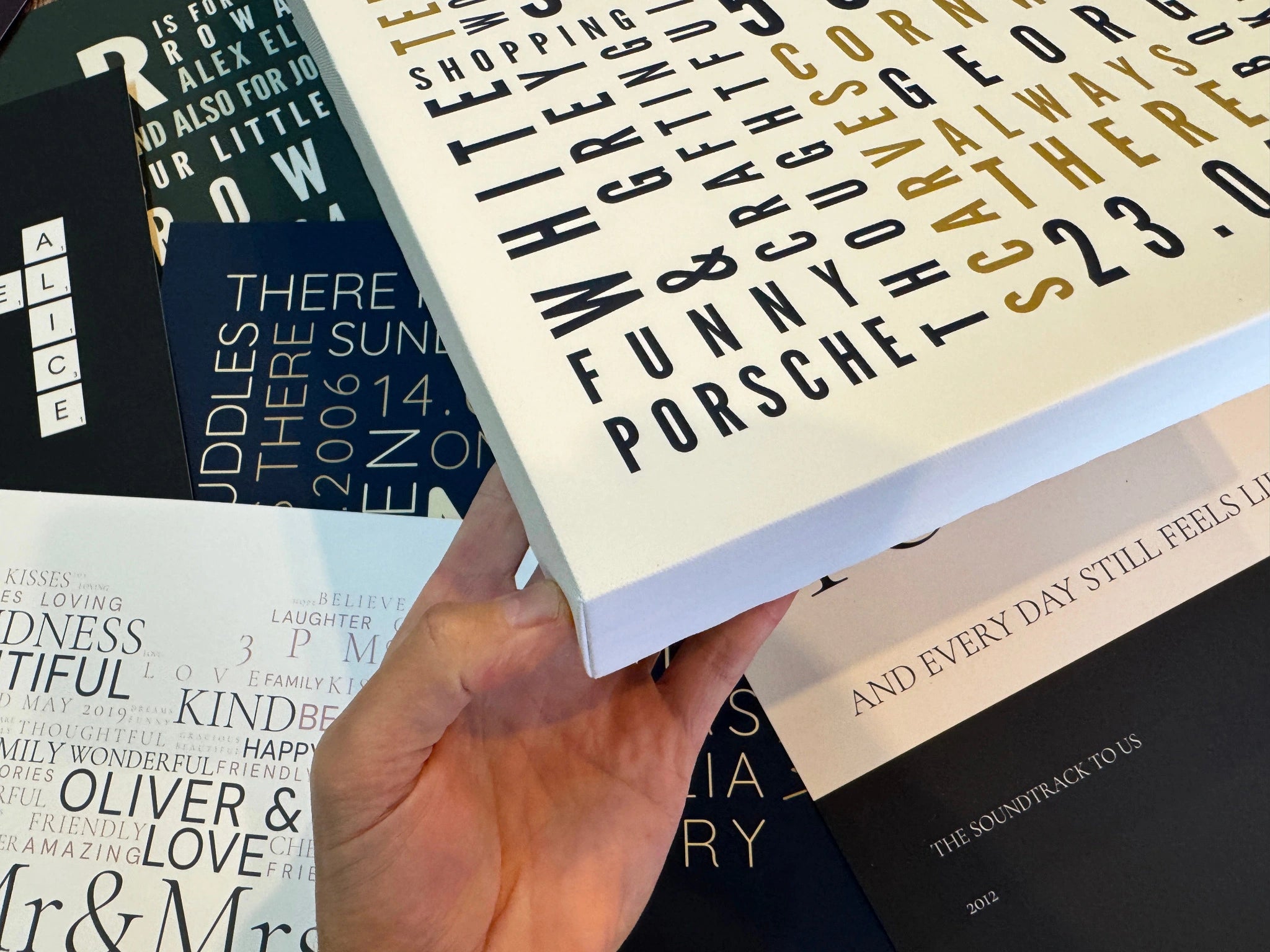 A chunky Word Art canvas above several poster designs, showing its wrapped side and print detail.
