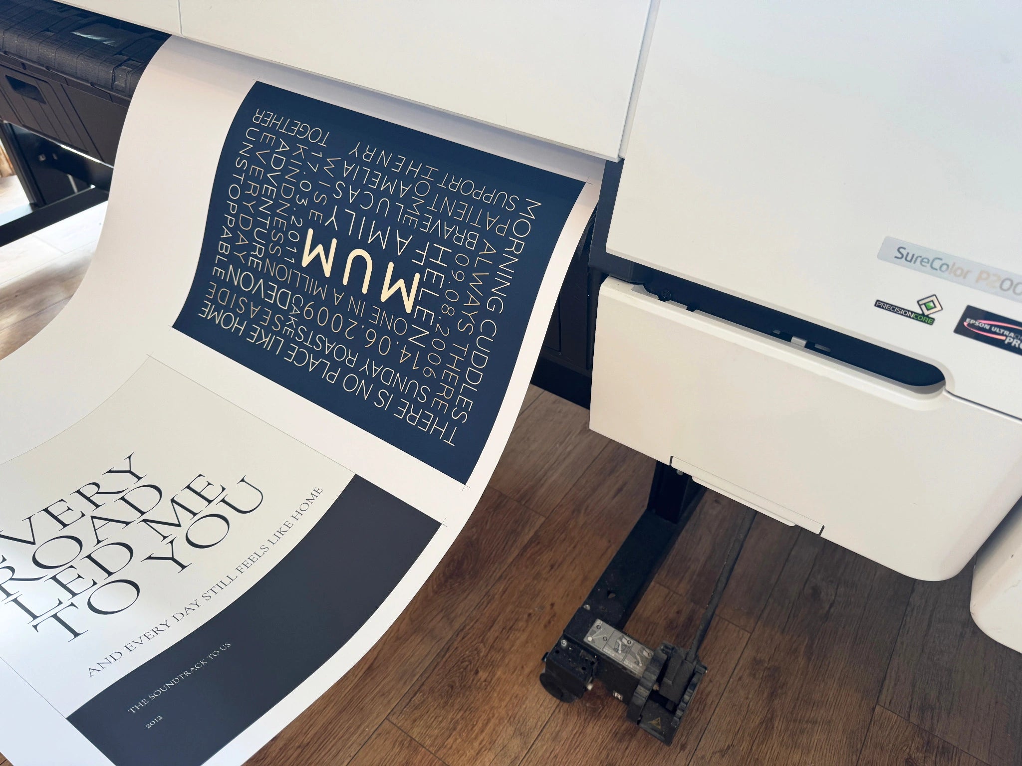 A navy Mum Word Art design coming off an Epson printer in the YI2C workshop.