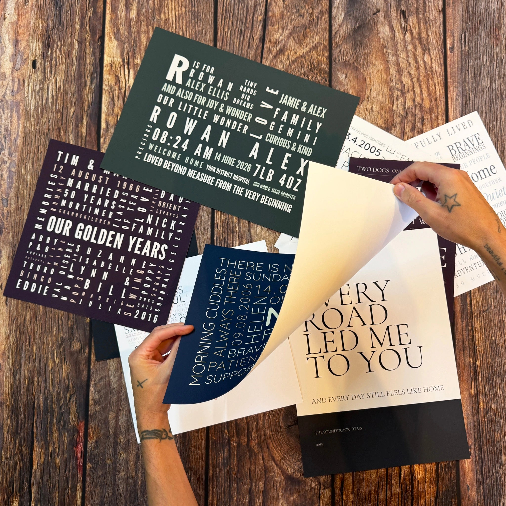 Hands lifting the paper corner of a Word Art poster above a collection of printed designs.