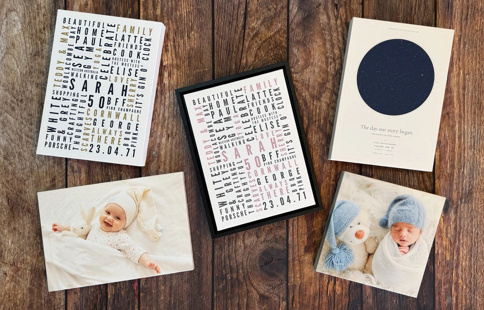 Five finished photo, Word Art and Star Map prints arranged on our wooden workshop worktop