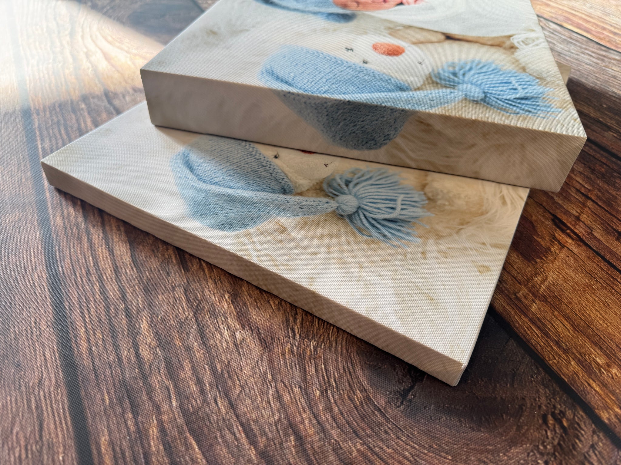 Two newborn photo canvases stacked to show their depth and wrapped sides.