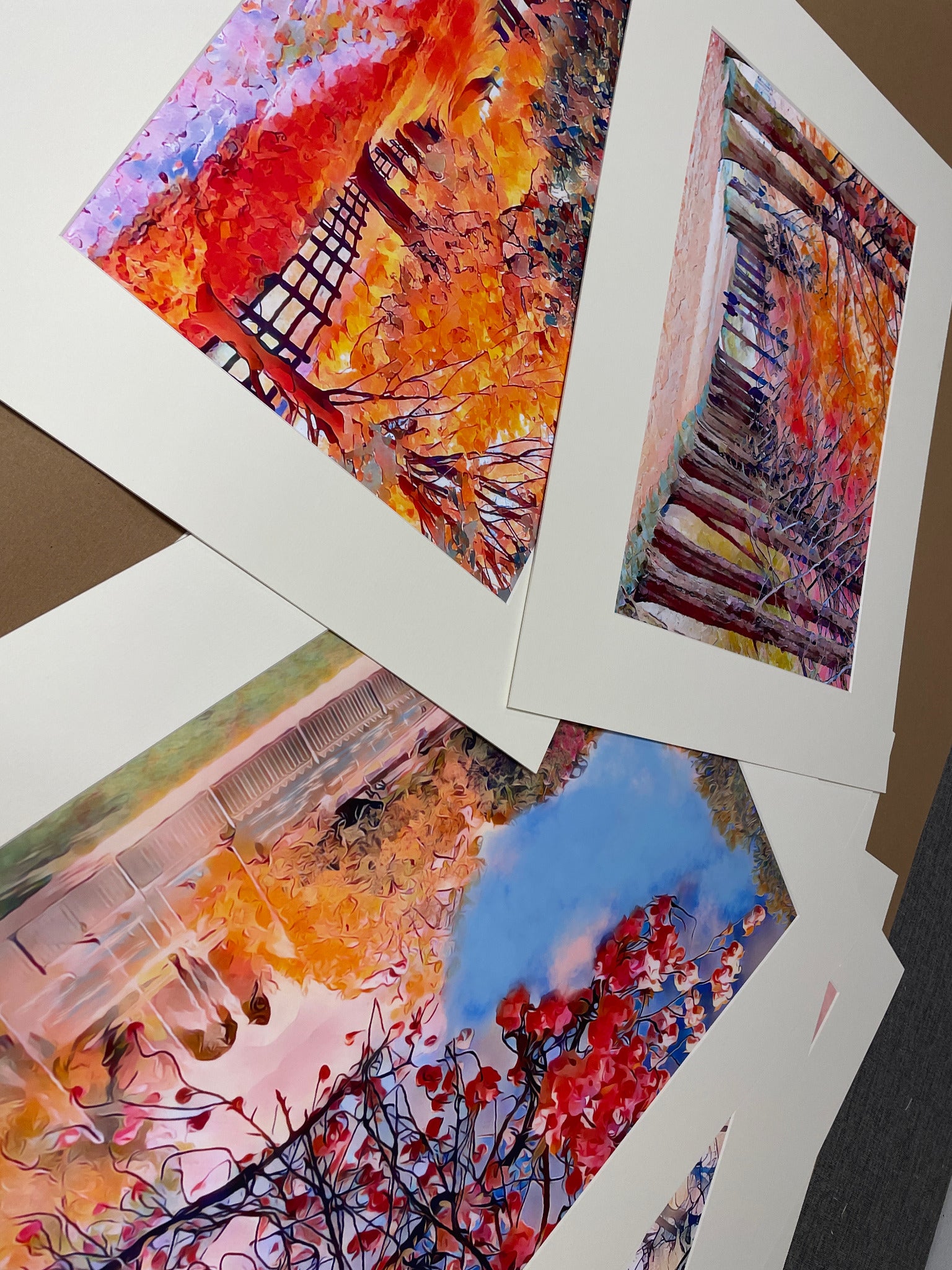 Colourful artwork prepared in white mounts before framing