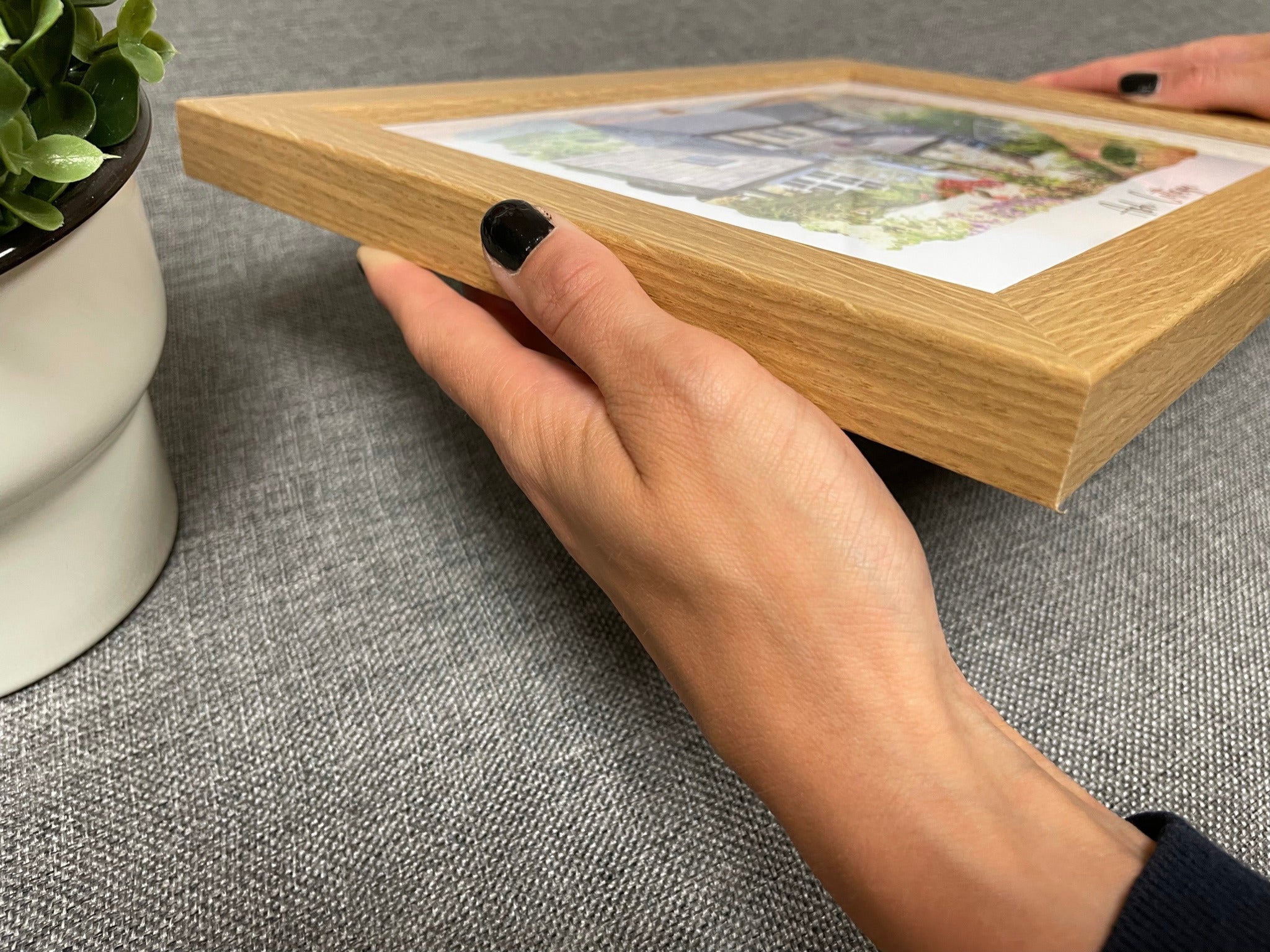 A close view of an oak-finish frame held by hand