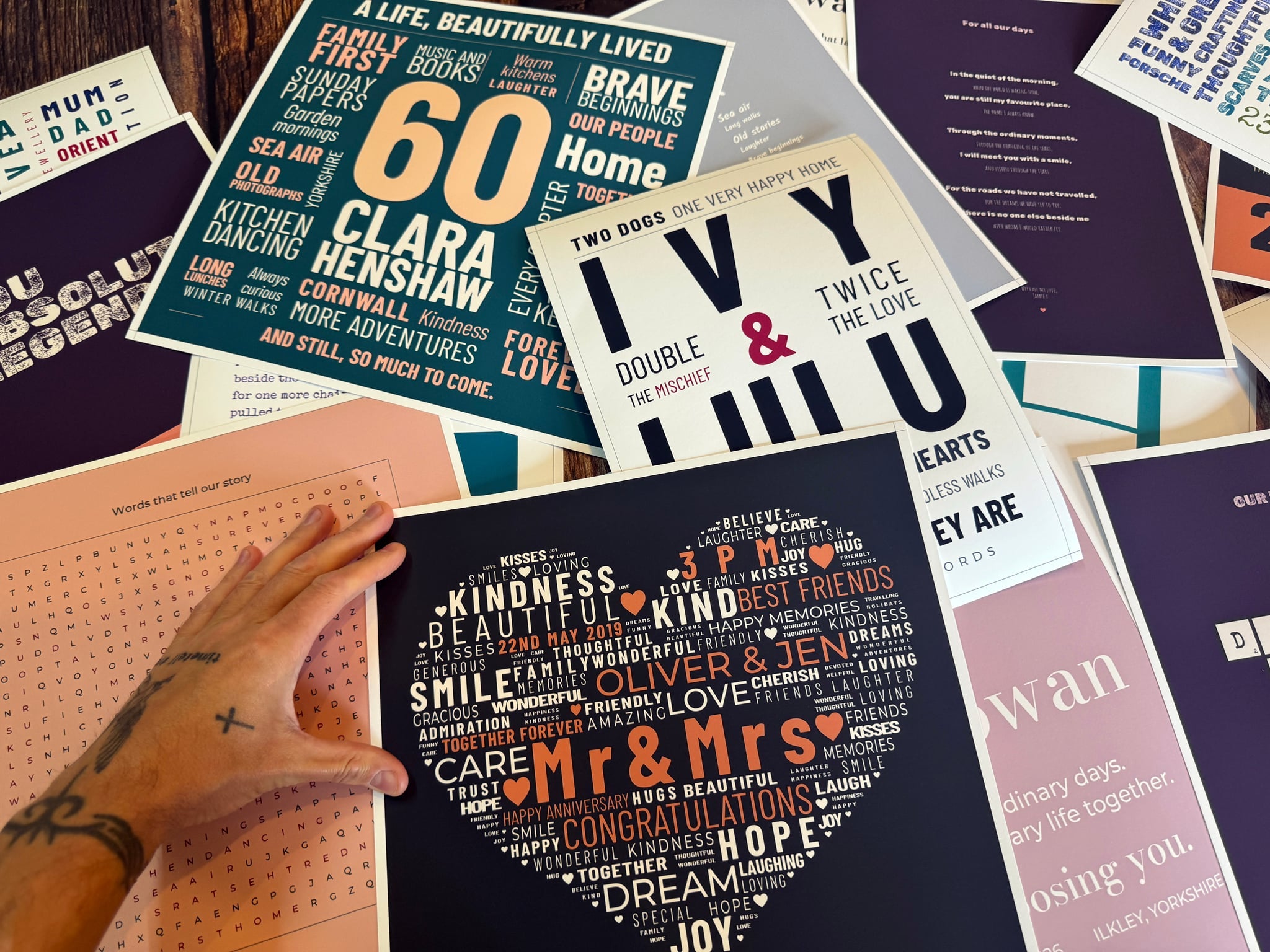 Genuine personalised Word Art prints photographed together, including a 60th birthday design, IVY and LULU typography and a heart-shaped wedding word design