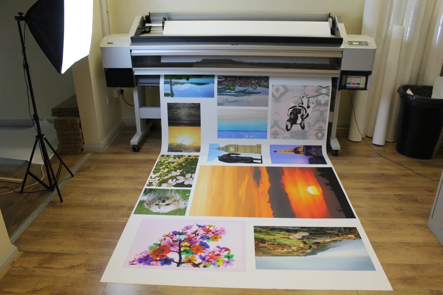 Workshop product photography setup with a large-format printer, lighting stand and printed floor backdrops