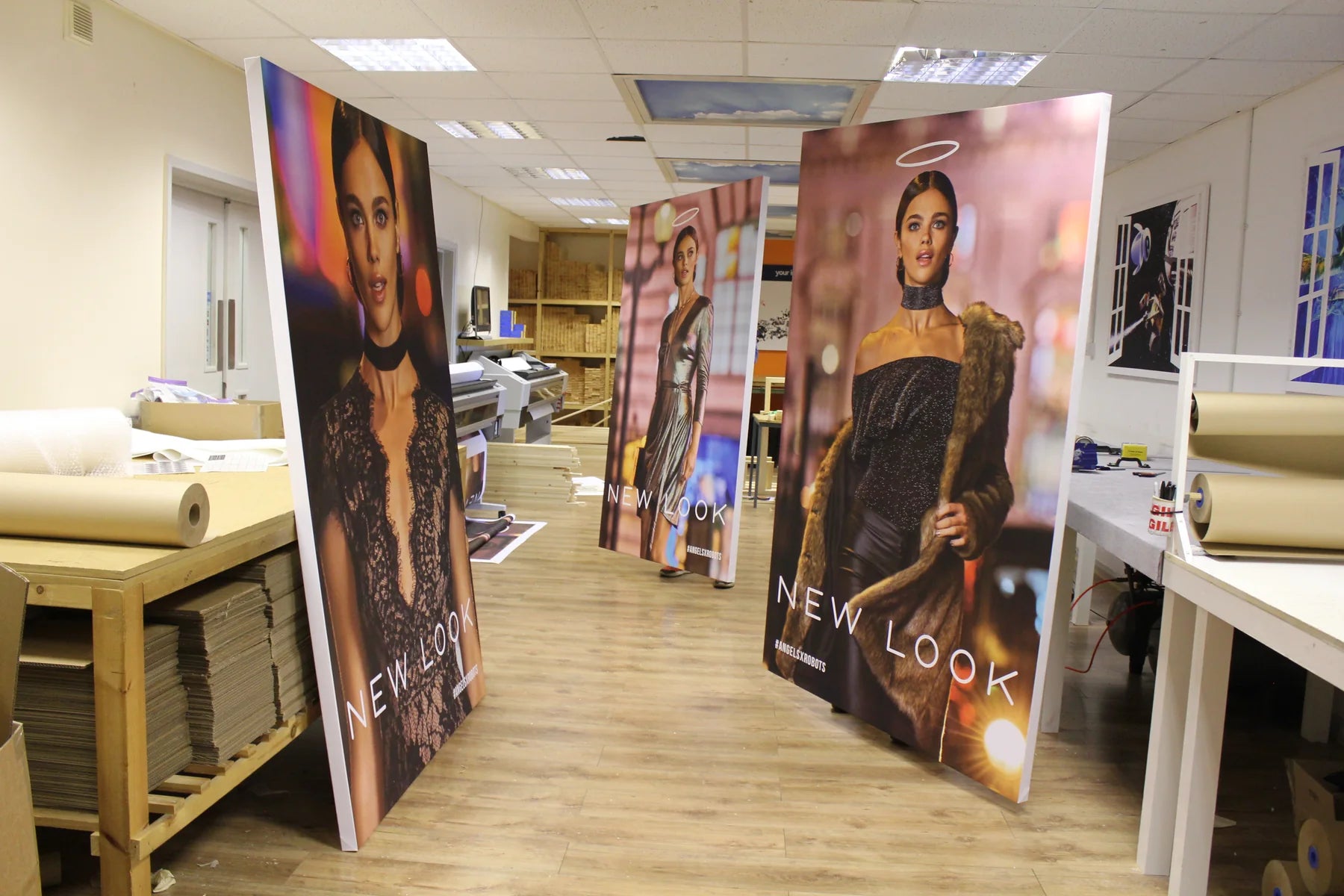Oversized fashion display panels arranged through the workshop