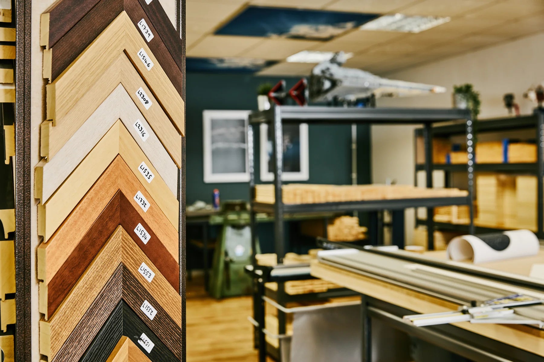Frame corner samples beside the production benches and timber shelves