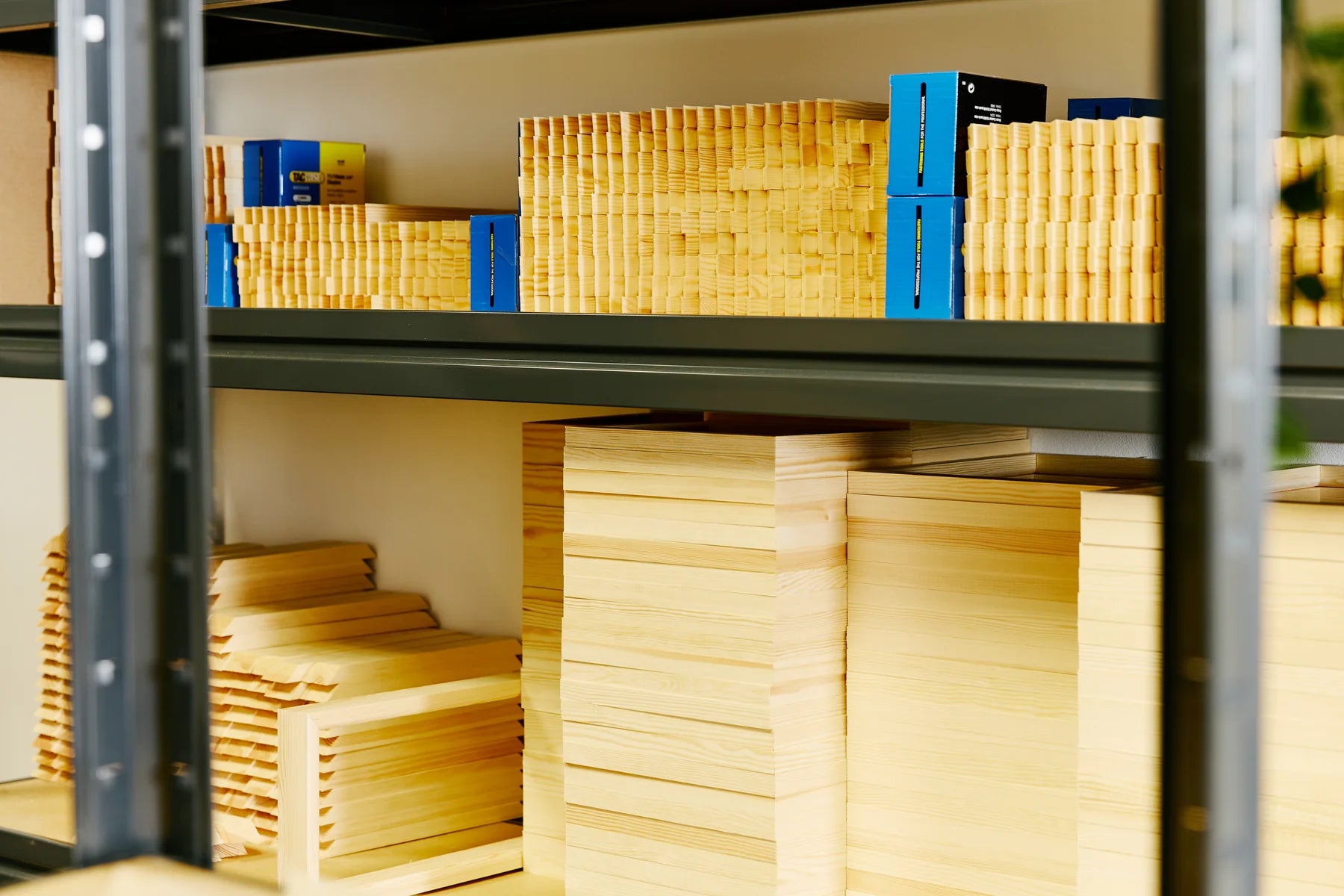 Cut timber and canvas corner wedges stored on workshop shelving