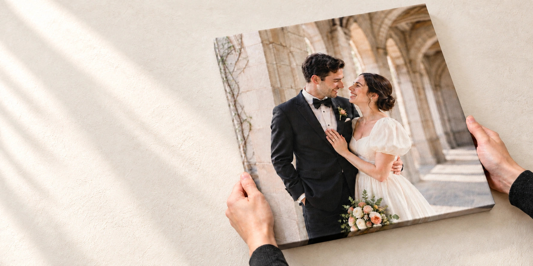 Wedding photo canvas print held above a warm cream floor.