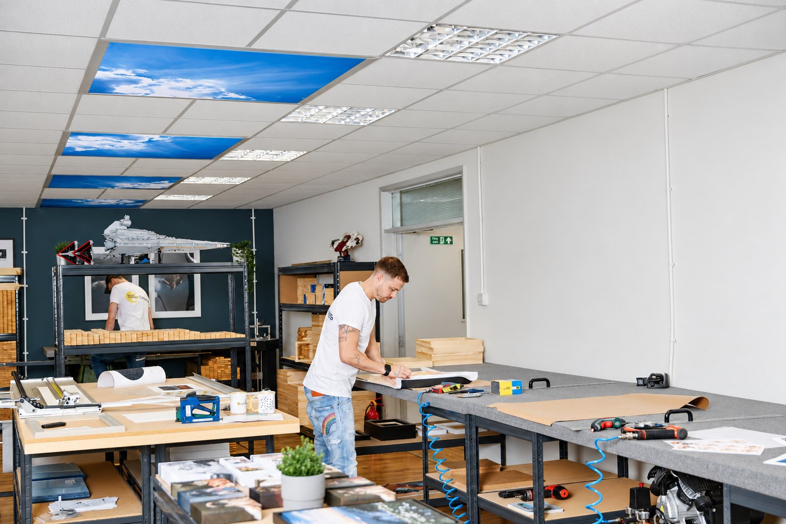 A YI2C canvas maker working at a bench in the West Yorkshire production studio