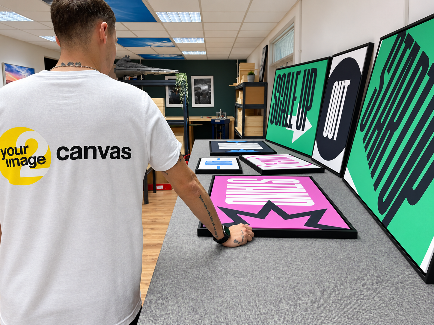 A YI2C team member checking a collection of completed prints in the workshop