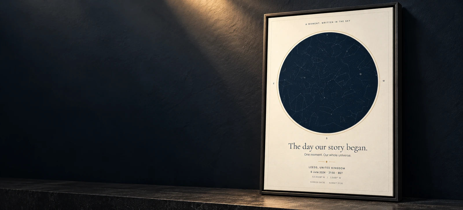 Classic Star Map canvas in a black floating wood frame against a dramatically lit charcoal wall