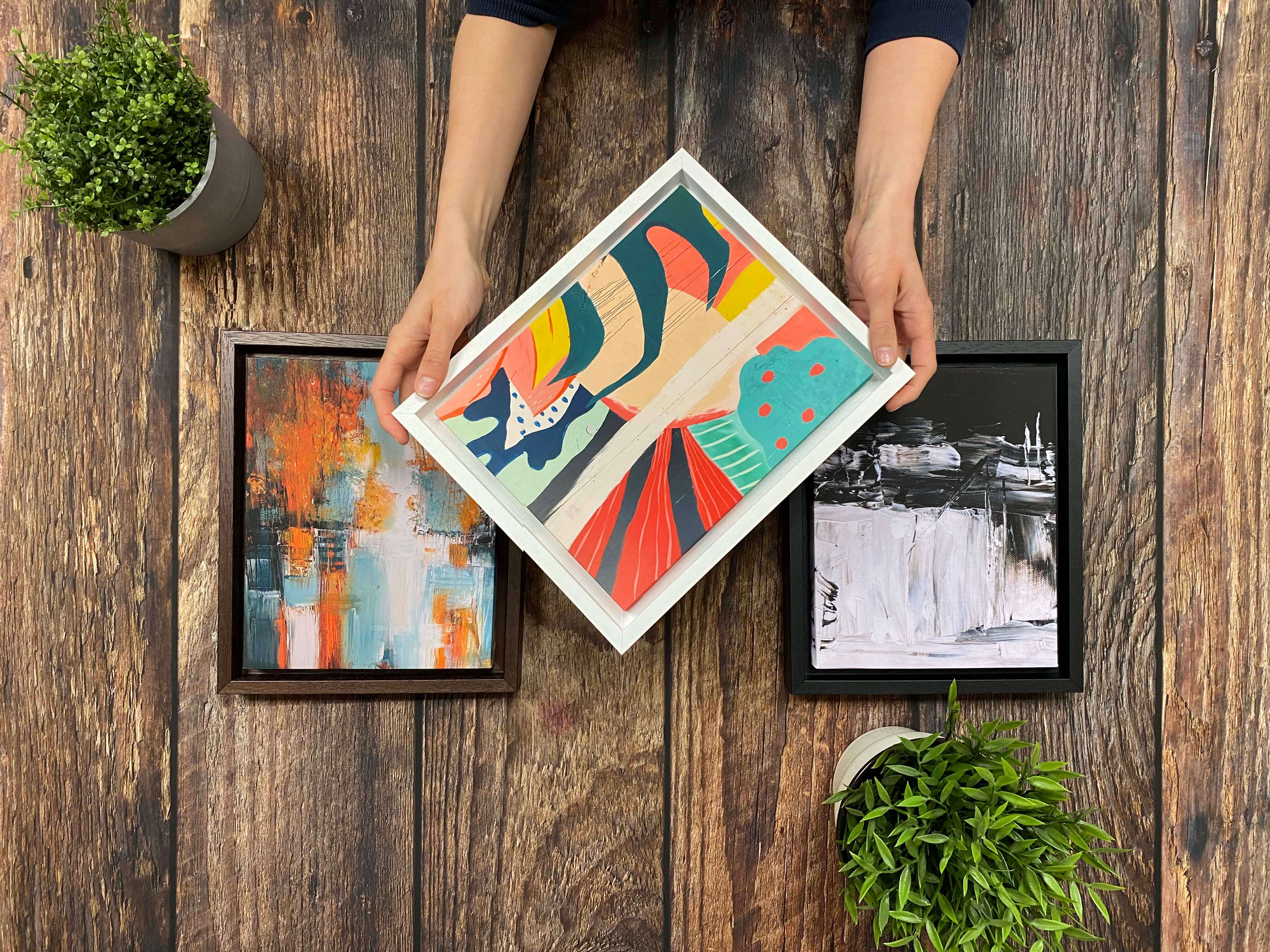Three colourfulhand made abstract canvas prints displayed in quality white, black and dark wood box frames for a touch of luxury.