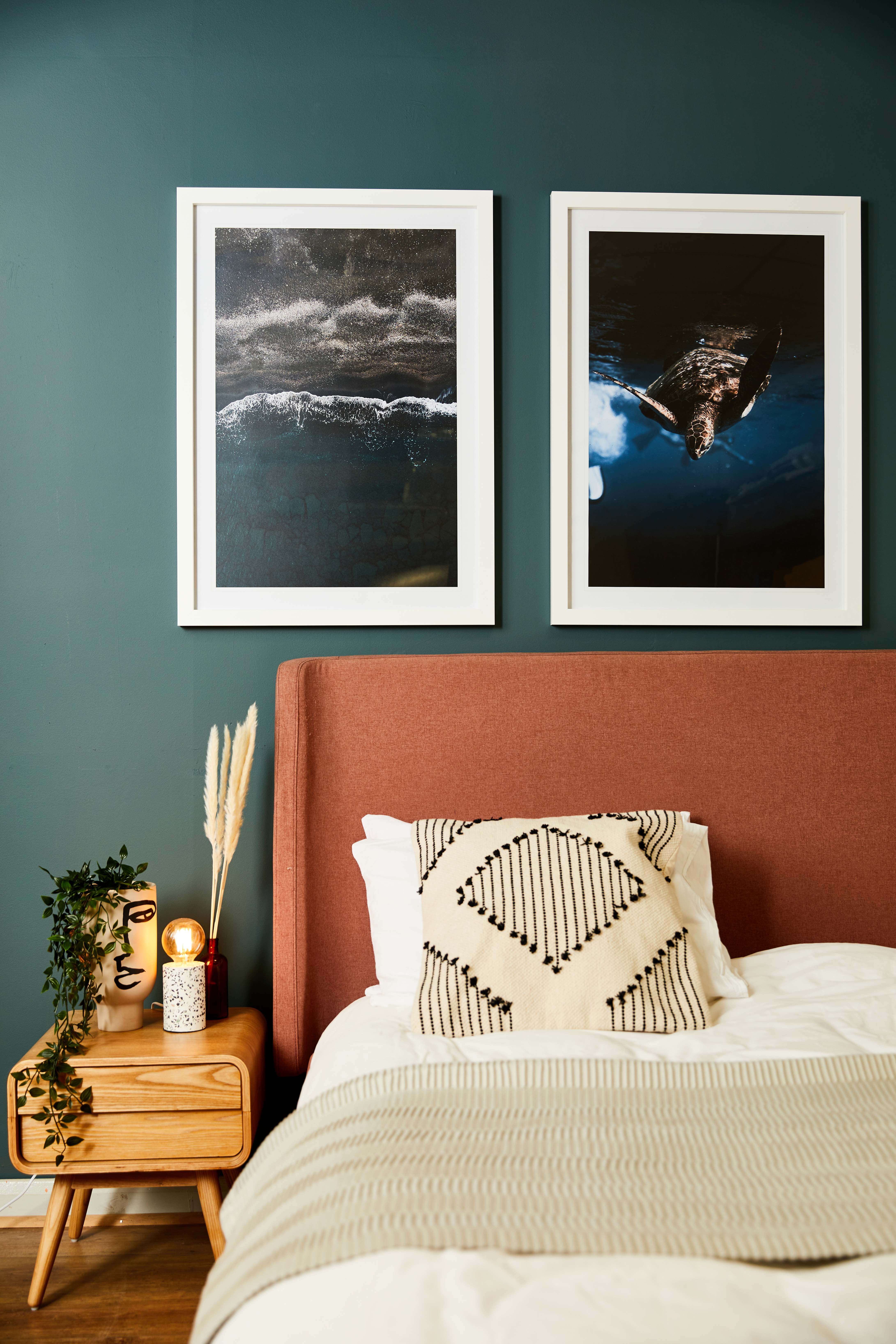 Two large quality white framed photo prints displayed above bed for perfect personalised home decor ideas