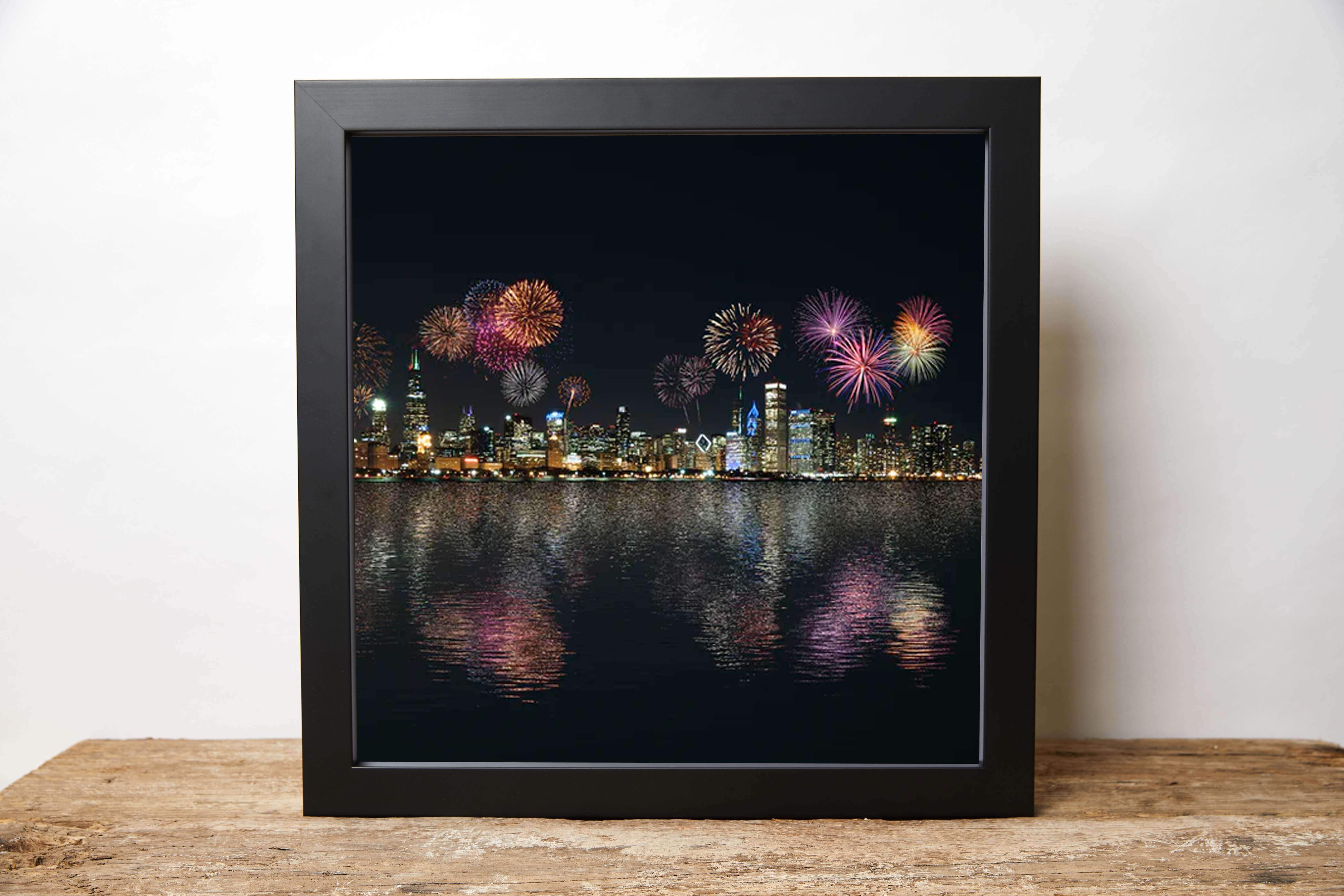 a stunning photograph of bonfire night in the city with colourful fireworks printed onto quality but affordable canvas and displayed in a hand made black frame